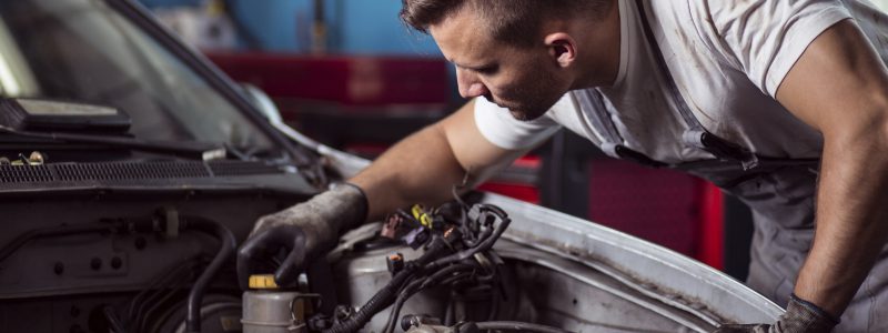 Close-up of auto mechanic repairing car engine